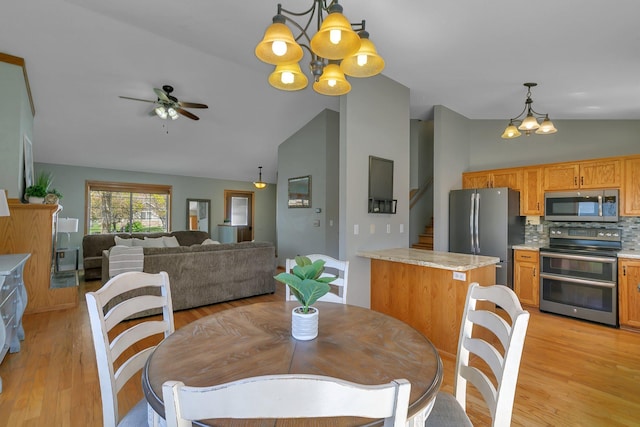 1908 5th St N, Sartell, MN 56377 - dining area with a chandelier, light wood-style flooring, ceiling fan, high vaulted ceiling, and stairs