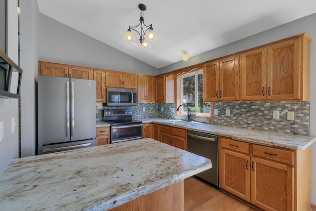 1908 5th St N, Sartell, MN 56377 - kitchen with stainless steel appliances, a sink, lofted ceiling, tasteful backsplash, and a chandelier