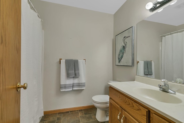 1908 5th St N, Sartell, MN 56377 - full bath featuring vanity, baseboards, toilet, and stone finish flooring