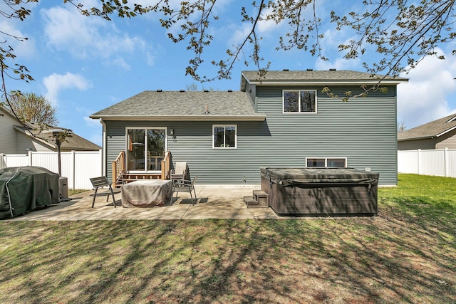 1908 5th St N, Sartell, MN 56377 - back of house featuring a hot tub, a patio, and roof with shingles