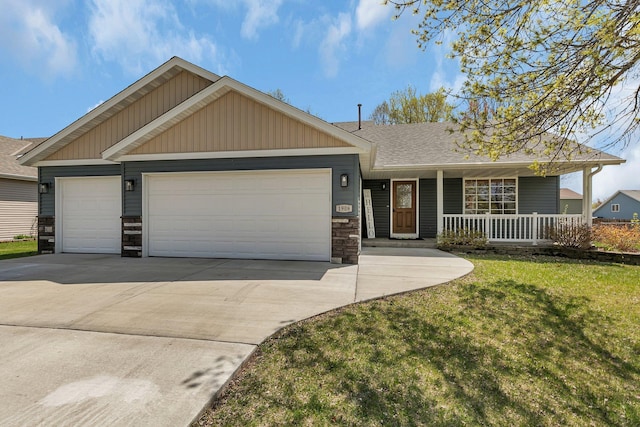 1908 5th St N, Sartell, MN 56377 - view of front facade with a garage, concrete driveway, a front yard, and stone siding