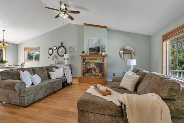 1908 5th St N, Sartell, MN 56377 - living room with vaulted ceiling, light wood finished floors, a ceiling fan, and a chandelier