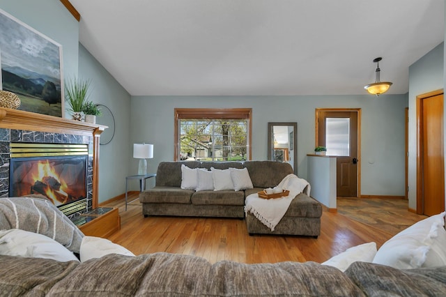 1908 5th St N, Sartell, MN 56377 - living room featuring wood finished floors, lofted ceiling, baseboards, and a high end fireplace