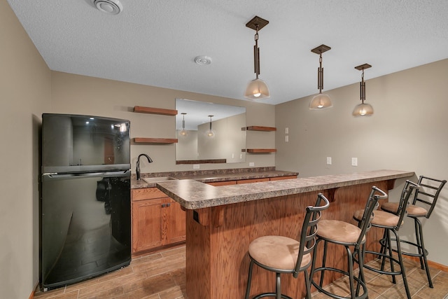 1908 5th St N, Sartell, MN 56377 - kitchen featuring freestanding refrigerator, a sink, a peninsula, open shelves, and light wood-style floors