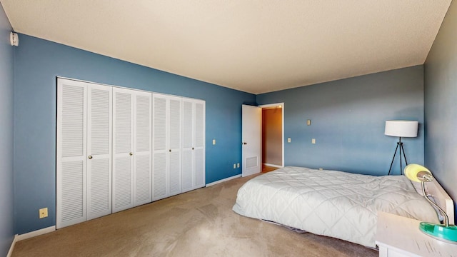 bedroom featuring carpet, baseboards, and a closet