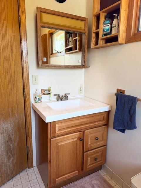 bathroom with tile patterned floors and vanity