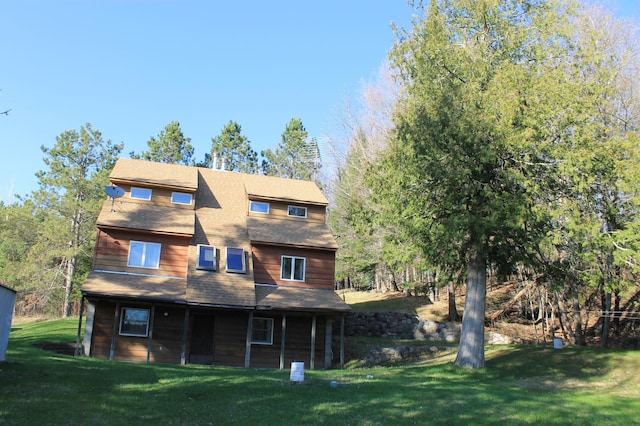 back of property featuring a lawn