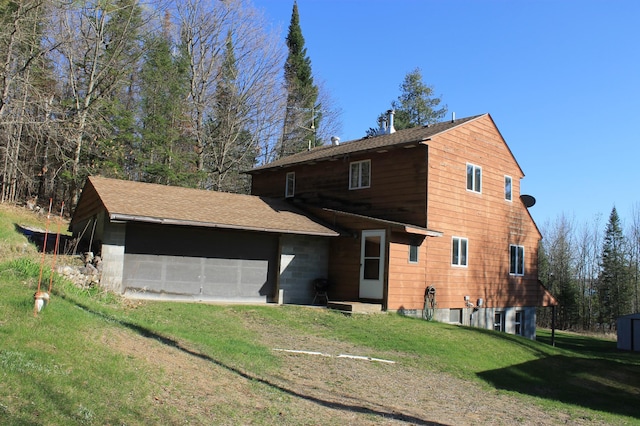 view of front of home featuring a front yard and roof with shingles