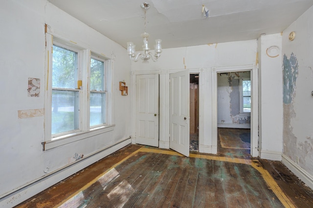 414 4th St, Winthrop, MN 55396 - unfurnished dining area featuring baseboard heating, wood-type flooring, and a chandelier