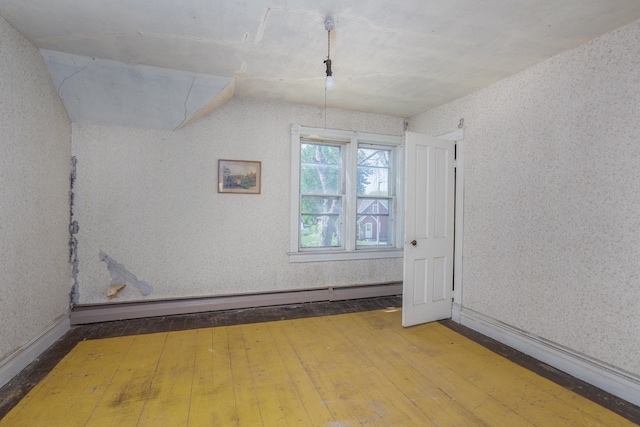 414 4th St, Winthrop, MN 55396 - bonus room with wood-type flooring, a baseboard radiator, lofted ceiling, wallpapered walls, and baseboards