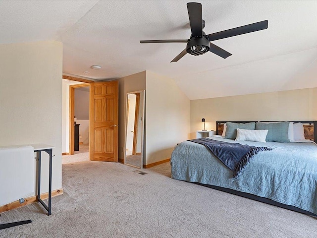 bedroom featuring carpet flooring, vaulted ceiling, baseboards, and a ceiling fan