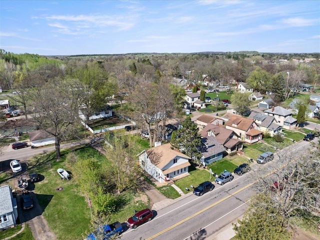 aerial view of property and surrounding area featuring nearby suburban area