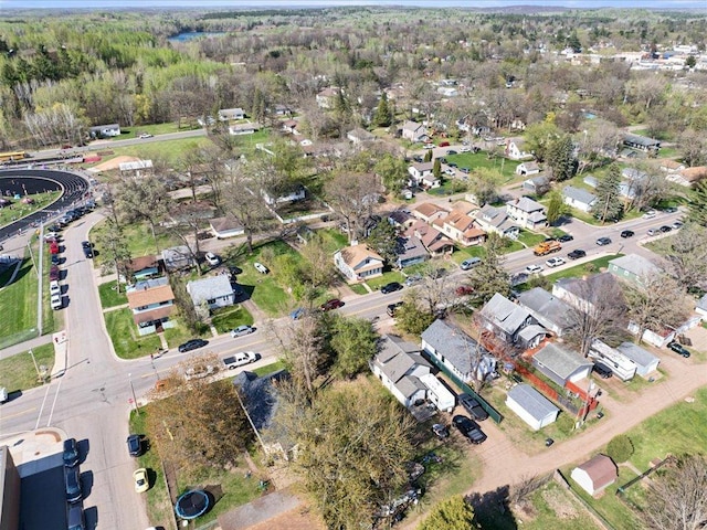 aerial overview of property's location featuring nearby suburban area and a forest