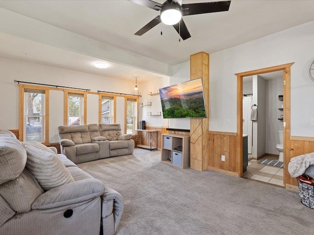 611 3rd St SW, Crosby, MN 56441 - living area featuring wooden walls, wainscoting, carpet flooring, and ceiling fan