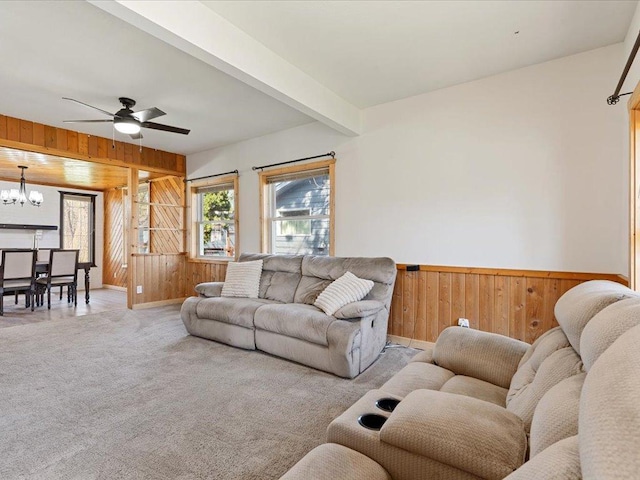 611 3rd St SW, Crosby, MN 56441 - living area featuring wood walls, a chandelier, carpet floors, ceiling fan, and baseboards