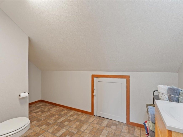 611 3rd St SW, Crosby, MN 56441 - bonus room with a textured ceiling, baseboards, brick patterned flooring, and vaulted ceiling