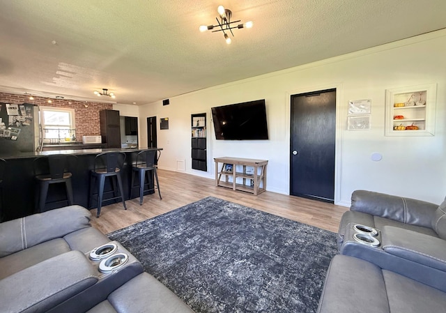 513 Water Ave N, Saint Hilaire, MN 56754 - living area featuring light wood-style floors, a textured ceiling, and baseboards