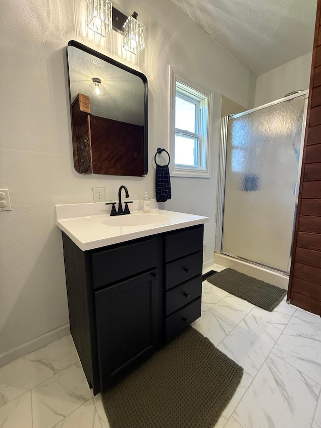 513 Water Ave N, Saint Hilaire, MN 56754 - full bath featuring marble finish flooring, a shower stall, vanity, baseboards, and a textured ceiling