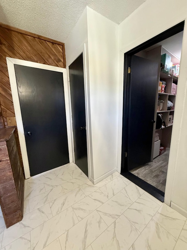 513 Water Ave N, Saint Hilaire, MN 56754 - hallway with marble finish floors and wooden walls
