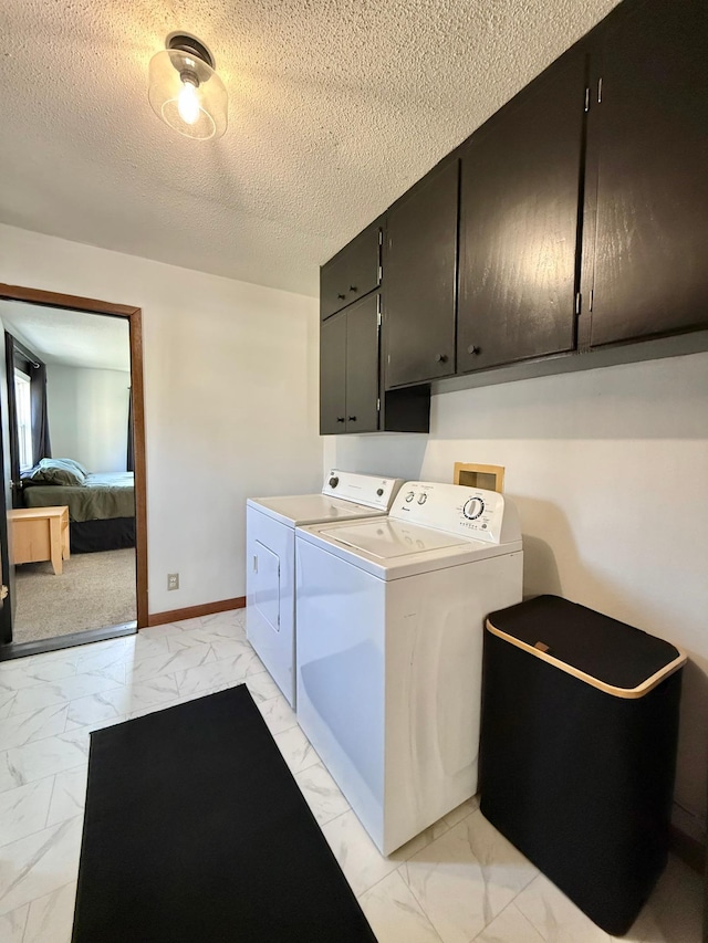 513 Water Ave N, Saint Hilaire, MN 56754 - clothes washing area with light marble finish floors, independent washer and dryer, cabinet space, a textured ceiling, and baseboards