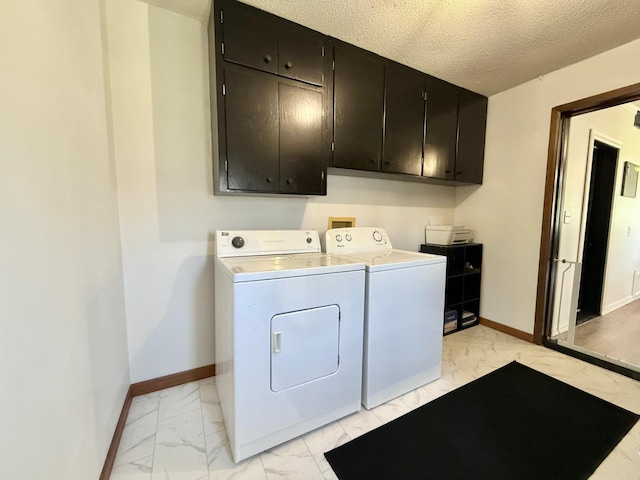 513 Water Ave N, Saint Hilaire, MN 56754 - washroom with light marble finish floors, cabinet space, washer and dryer, baseboards, and a textured ceiling