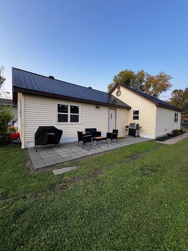513 Water Ave N, Saint Hilaire, MN 56754 - rear view of house with a lawn, a patio area, and metal roof