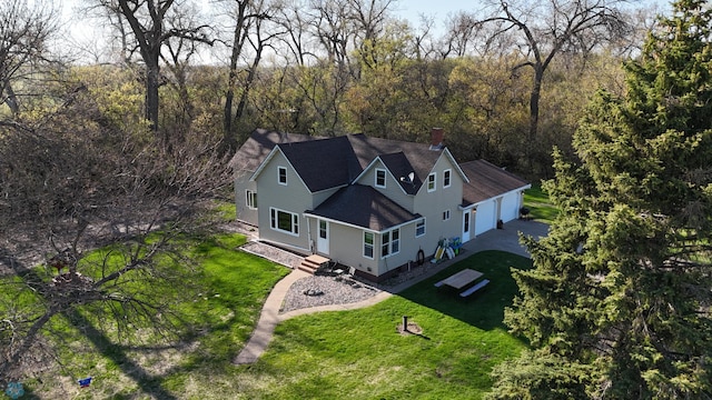 birds eye view of property with a forest view