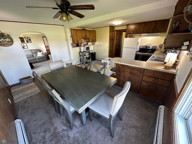 dining area with arched walkways, carpet flooring, and ceiling fan