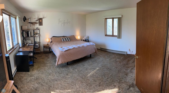 bedroom with carpet, multiple windows, and a baseboard heating unit