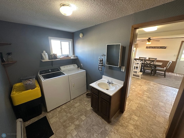laundry room with a sink, laundry area, a textured ceiling, washer and dryer, and a ceiling fan