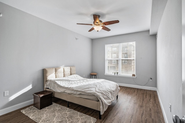 bedroom with baseboards, wood finished floors, and ceiling fan