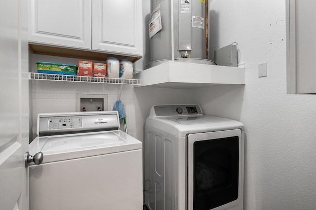 washroom with washer and dryer, cabinet space, and water heater