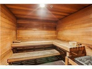 relaxing sauna / steam room featuring wood walls and wood ceiling