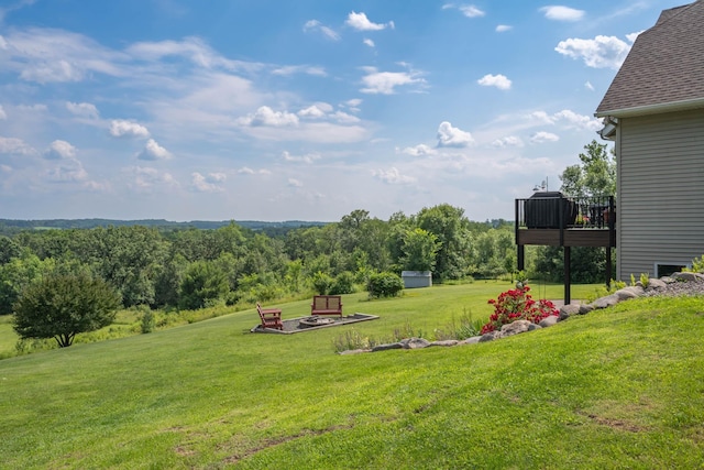 532 150th St, Alden Twp, WI 54001 - view of green lawn with a deck and an outdoor fire pit