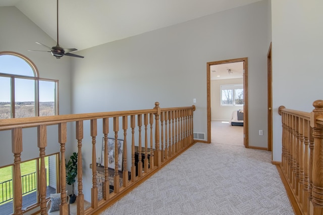 532 150th St, Alden Twp, WI 54001 - hallway featuring an upstairs landing, high vaulted ceiling, carpet flooring, and baseboards