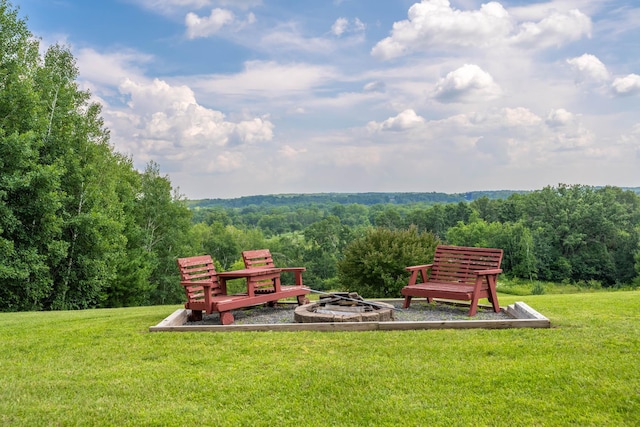 532 150th St, Alden Twp, WI 54001 - view of green lawn featuring an outdoor fire pit and a wooded view
