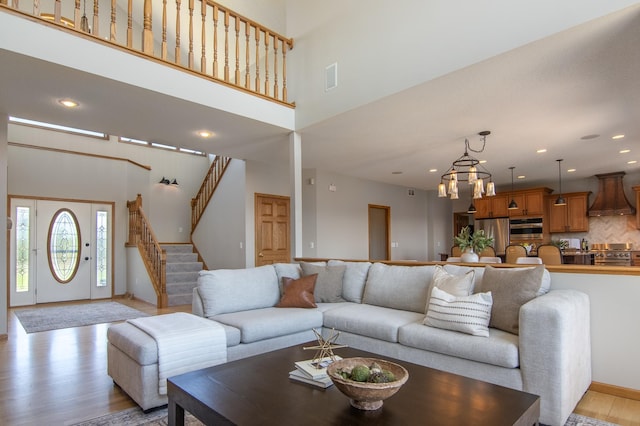 532 150th St, Alden Twp, WI 54001 - living area featuring light wood-type flooring, stairway, recessed lighting, and a high ceiling