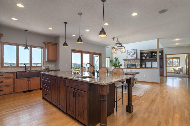532 150th St, Alden Twp, WI 54001 - kitchen with a sink, a breakfast bar area, recessed lighting, light wood-style flooring, and an island with sink