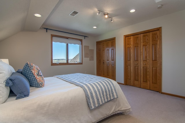 532 150th St, Alden Twp, WI 54001 - bedroom featuring two closets, light colored carpet, recessed lighting, baseboards, and vaulted ceiling