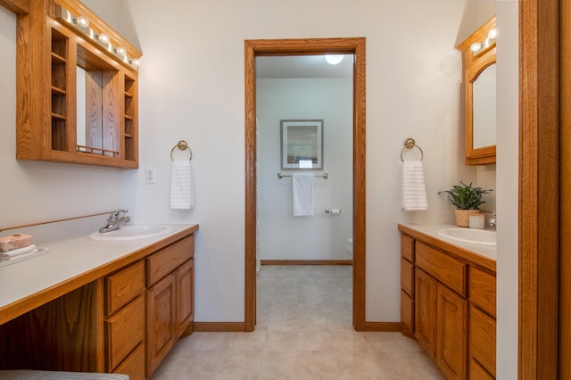 532 150th St, Alden Twp, WI 54001 - full bath featuring two vanities, toilet, and baseboards