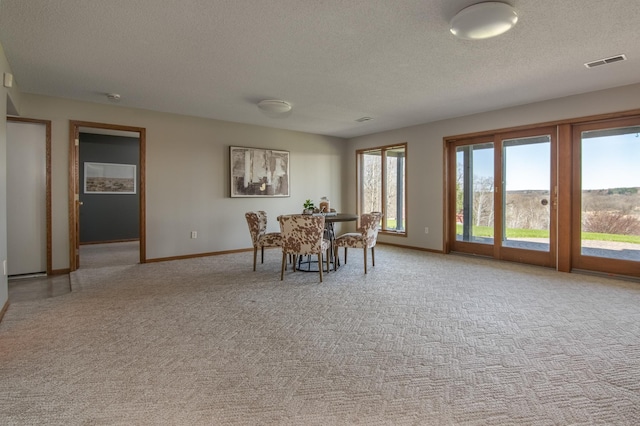 532 150th St, Alden Twp, WI 54001 - dining area with a textured ceiling, light colored carpet, and baseboards