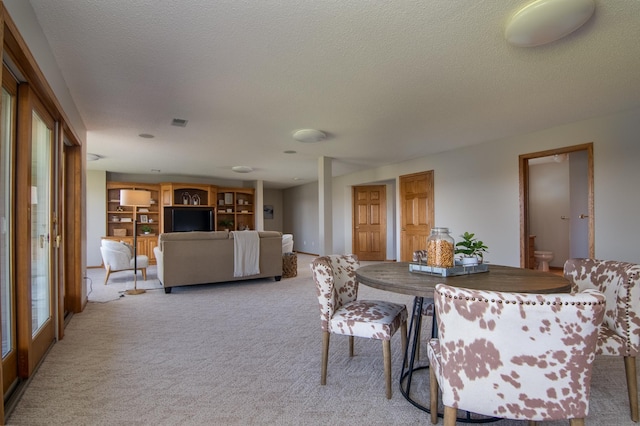 532 150th St, Alden Twp, WI 54001 - dining area with light colored carpet and a textured ceiling
