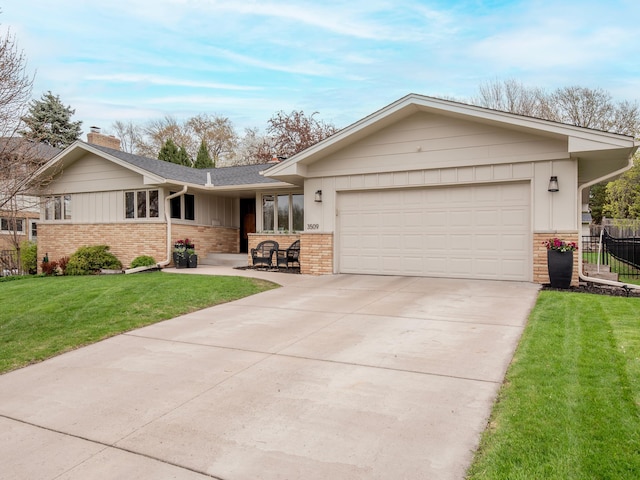 3509 Coolidge St NE, Saint Anthony, MN 55418 - single story home with brick siding, a chimney, a garage, and driveway