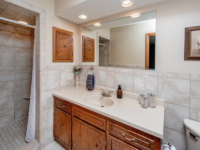 3509 Coolidge St NE, Saint Anthony, MN 55418 - bathroom with tile walls, vanity, a stall shower, and wainscoting