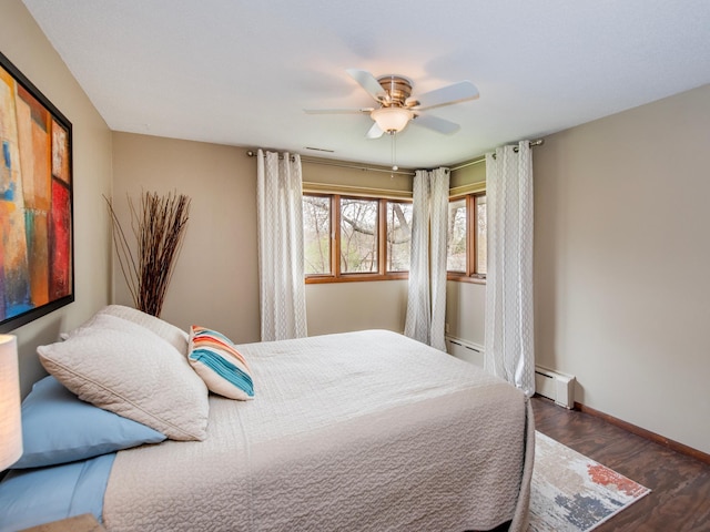3509 Coolidge St NE, Saint Anthony, MN 55418 - bedroom with baseboard heating, wood finished floors, and ceiling fan