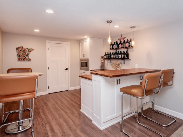 3509 Coolidge St NE, Saint Anthony, MN 55418 - indoor dry bar with stainless steel microwave, wood finished floors, recessed lighting, and pendant lighting