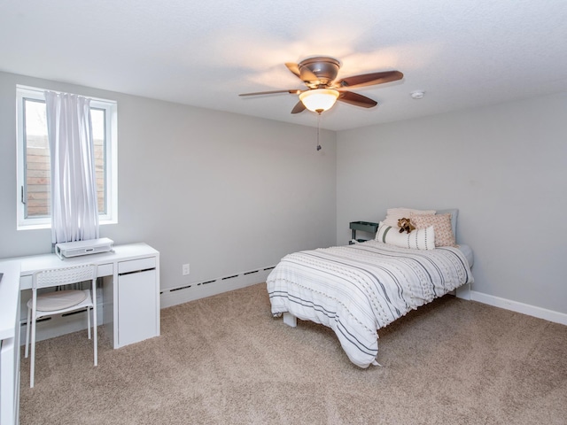 3509 Coolidge St NE, Saint Anthony, MN 55418 - bedroom with a baseboard radiator, light carpet, and a ceiling fan