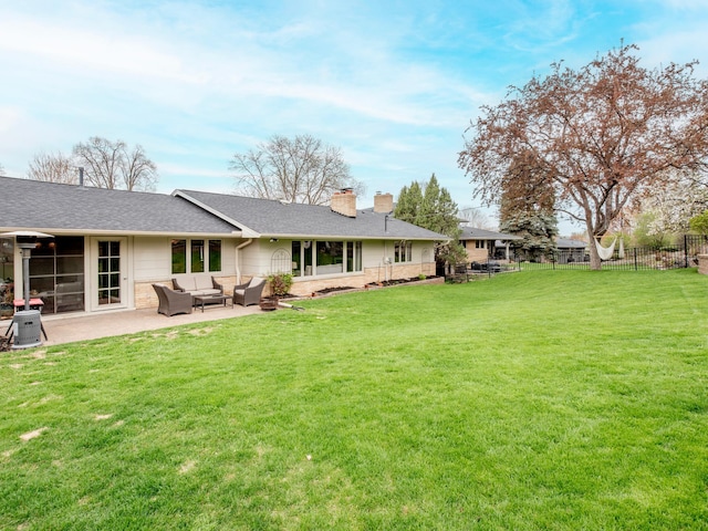 3509 Coolidge St NE, Saint Anthony, MN 55418 - back of house featuring an outdoor hangout area, a chimney, a patio area, and a shingled roof