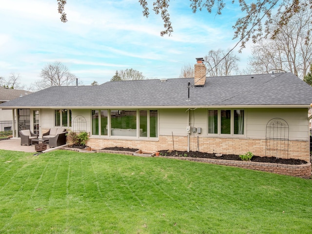 3509 Coolidge St NE, Saint Anthony, MN 55418 - rear view of house featuring an outdoor living space, brick siding, a chimney, and a lawn