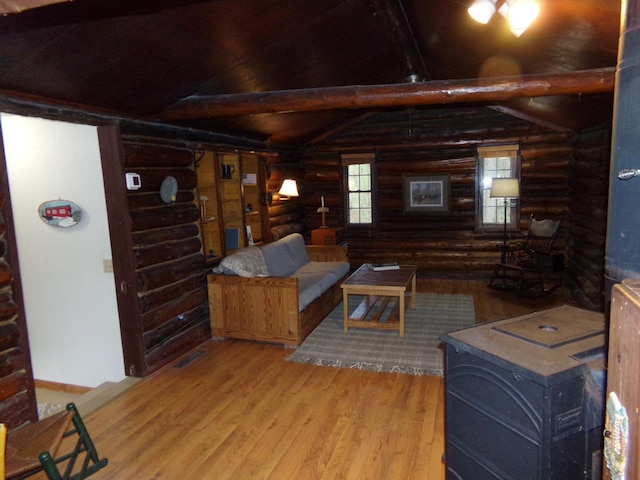 living area with rustic walls, wood finished floors, and wooden ceiling